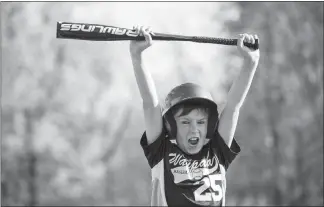  ?? LAUREN JUSTICE / THE NEW YORK TIMES ?? Ryder Vergauwen, 10, yells in excitement May 20 after hitting a home run, while holding a new USA Baseballap­proved bat in Waupaca, Wis.