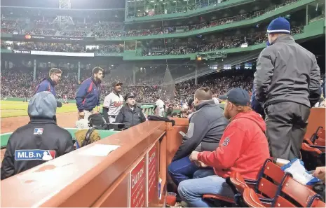  ?? AVI MILLER/@AVIMIIIER ?? The Orioles’ Adam Jones looks into the Fenway Park stands after a bag of peanuts was thrown at him Monday night.