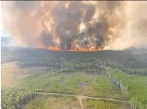  ?? ALBERTA WILDFIRE VIA REUTERS ?? Smoke rises from a wildfire near Grande Prairie, Alta. As of Tuesday, there were 28 wildfires burning in Saskatchew­an, more than double the typical amount at this time of year.