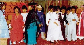  ??  ?? A young Kass Naidoo (red dress) as part of the cast in a school production of
Cinderella.