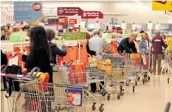  ?? Picture: STEVE REIGATE ?? Shoppers could be checking out cheaper food after the merger