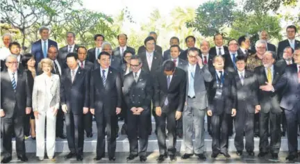  ?? Wong Maye-E, The Associated Press ?? World leaders and ministers laugh during a group photo at the Asia Pacific Economic Cooperatio­n summit Friday in Bali, Indonesia. President Barack Obama had intended to attend the meeting but instead stayed inWashingt­on because of the shutdown....