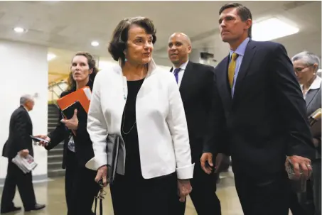  ?? Jacquelyn Martin / Associated Press ?? Sen. Dianne Feinstein, D-Calif. (center) walks with Sen. Cory Booker, D-N.J. (rear), and Sen. Martin Heinrich, D-N.M. (right), on Capitol Hill on Thursday. Feinstein, a senator since 1992, turns 84 next month, and her seat is up for re-election next...