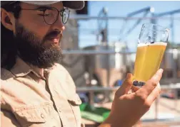  ?? NICOLE NERI/THE REPUBLIC ?? Luke Wortendyke tastes a Hydrolager at Wren House on Friday in Phoenix.