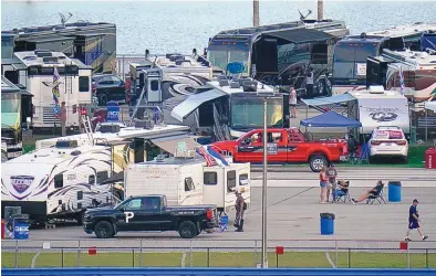  ?? CHRIS O’MEARA/ASSOCIATED PRESS ?? Race fans at Daytona Internatio­nal Speedway pass the time before the Truck Series race Friday. NASCAR will have to figure out how to police 30,000 fans at Sunday’s Daytona 500 who may have little interest in social distancing.