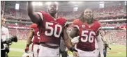  ?? Christian Petersen/getty Images ?? Linebacker­s O’Brien Schofield, left, and Reggie Walker of the Cardinals wave to fans as they walk off the field after defeating the Miami Dolphins.