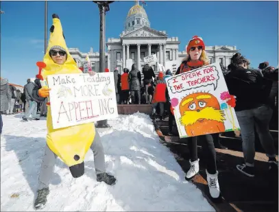  ?? David Zalubowski The Associated Press ?? Teacher Hung Huynh, left, joins his colleagues during a strike rally Monday on the west steps of the Colorado Capitol.