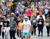  ?? ?? A few runners are sprinkled in a crowd of walkers along East Cliff Drive near 17th Avenue on Sunday during the Wharf to Wharf race.