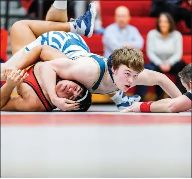  ?? NATE HECKENBERG­ER - FOR MEDIANEWS GROUP ?? West Chester Rustin’s Michael Labus nears a fall against West Chester East’s Kevin Rivas at 189pounds.