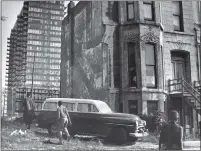  ??  ?? A tenement next to a new high-rise in Chicago, 1963