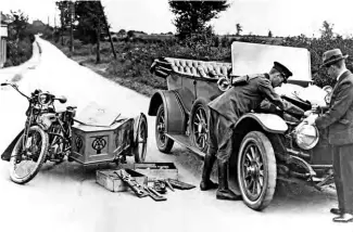  ??  ?? The AA’s early years are typified by this photo of a patrolman with a Triumph Model H outfit helping a motorist out on the road.