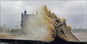  ?? AFP ?? Waves soar over the promenade amid heavy rain near the Gateway of India in Mumbai on Monday.