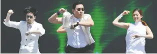  ?? AFP/GETTY IMAGES ?? South Korean singer Psy, centre, said his monster hit Gangnam Style is meant to poke fun at Seoul’s ultra-wealthy Gangnam district. The song has more than three billion views on Youtube.