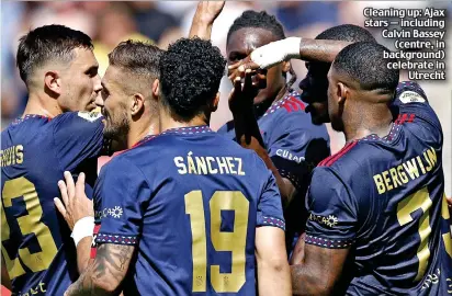  ?? ?? Cleaning up: Ajax stars — including Calvin Bassey (centre, in background) celebrate in Utrecht