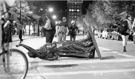  ?? EMILY HAMER/AP ?? Rioters in Madison, Wisconsin, tore down the “Forward” statue of a woman symbolical­ly pointing the future. Mayhem is underminin­g peaceful protests after George Floyd’s death.