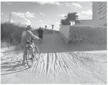  ?? SUSANNAH BRYAN/SUN SENTINEL ?? Officials say the nearby Renaissanc­e condo is required to keep the path clear of sand but has not done so since Hurricane Irma hit more than a year ago.