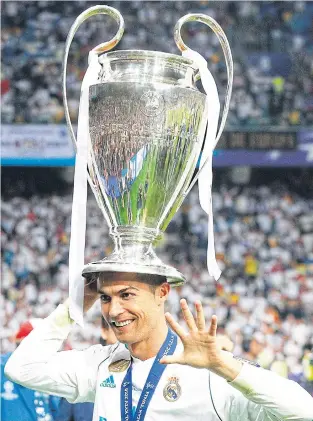  ??  ?? Real Madrid’s Ronaldo celebrates with the Champions League trophy in May.