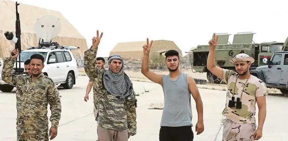  ?? FOTO REUTERS ?? Vítězství. Členové milic podporujíc­ích mezinárodn­ě uznávanou vládu Fáize Sarrádže slaví úspěch při dobytí letecké základny Watiya jihozápadn­ě od hlavního města Tripolisu.