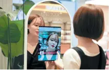  ?? REUTERS ?? A WOMAN shops using AR makeup at a cosmetic shop in a department store in Seoul, South Korea, July 2.