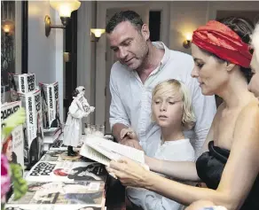  ?? PHOTOS: JACKIE MOLLOY/FOR THE WASHINGTON POST ?? Actor Liev Schreiber and his son Sasha talk to Posey during her book release party.