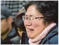  ?? REUTERS PIX ?? The ‘Sewol’ is seen during its salvage operations off Jindo in South Korea yesterday. (Inset) A relative of a missing victim crying.