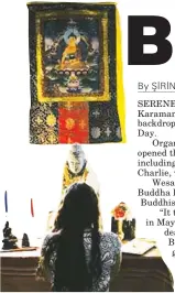  ??  ?? A woman worships at a Buddhist shrine at the home of Barrie Cotterell