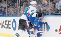  ?? JOHN MUNSON/AP ?? The Sharks’ Lane Pederson slams the Rangers’ Patrik Nemeth into the boards in the first period Friday in New York.