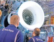  ??  ?? Rolls-royce engineers inspect a Trent 1000 engine.