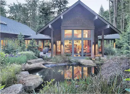  ??  ?? Homeowners Paul and Laurie Bride, architect Stephen Bobbitt and landscape architect Patrick Leuner collaborat­ed to create this home on Ames Lake near Seattle. The home consists of four pavilions, three of them connected by hallways.