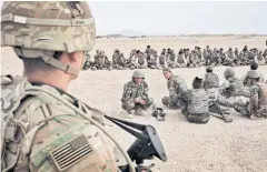  ??  ?? SEASONING FIGHTERS: US Army soldiers from the 2nd Battalion 87th Infantry Division oversee training of the 215th Corps at Camp Bastion in Helmand Province, Afghanista­n.