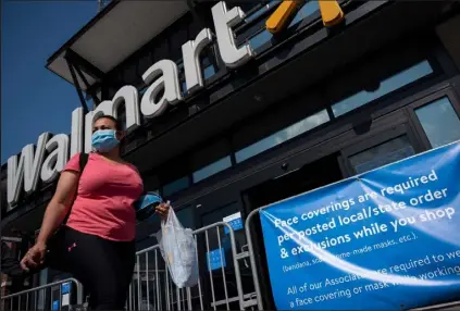  ?? Andrew Caballero-reynolds / Getty Images ?? The retail giant Walmart has seen earnings per share falling by about 1% this year, compared with a prior view of mid-single-digit gains.