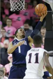  ?? STEPHAN SAVOIA — THE ASSOCIATED PRESS ?? Villanova guard Jalen Brunson (1) puts up a reverse layup as Providence guard Alpha Diallo (11) watches during the first half of an NCAA college basketball game Wednesday in Providence, R.I.