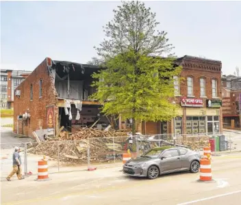  ?? STAFF FILE PHOTO BY TIM BARBER ?? Cheeburger Cheeburger is surrounded by a fence a day after its March collapse. The building at 138 Market St. has since been torn down.