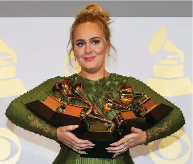  ?? PICTURE: REUTERS ?? MAJOR HAUL: Adele holds the five Grammys she won, including Record of the Year for Hello and Album of the Year for 25, during the 59th Annual Grammy Awards in Los Angeles on Sunday.