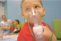  ?? RAMON ESPINOSA/ASSOCIATED PRESS ?? Yahir Garcia receives one of his two daily treatments for asthma on May 29 at a medical center in San Juan, Puerto Rico.