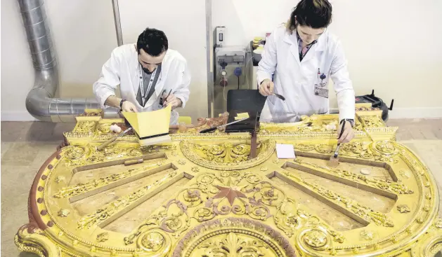  ??  ?? Restorers work on a piece with gold leafs from a bed belonging to Sultan Abdülaziz in the workshop in Istanbul, Feb. 14, 2019.