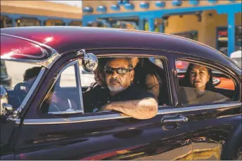  ?? ?? Roy Madrid I, center, drives his father’s 1947 Chevy Fleetline with loved ones through the plaza to honor the life of Max Madrid on Friday (Aug. 5).