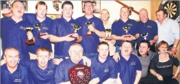  ?? ?? Mac’s Bar, Fermoy celebratin­g victory in the Fermoy Darts Associatio­n C&C Shield held in The Avondhu Bar in March, 2001 having defeated The Forge Bar team - back l-r: Timmy ‘DJ Razz’ Flynn, Daithí Sexton, Damien Murphy, John P Murphy, Jackie Fitzgerald (representi­ng James McCarthy), Robbie Donovan, Jimmy Corcoran and John Joe Murphy (coach); Front l-r: Pat Hurley, Shane O’Hara, Tommy Flynn (manager), Ken Nagle, Richard Flynn, Noel McCarthy and Mary McCarthy.