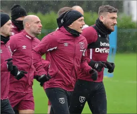  ??  ?? Gloves are on! Noble (centre) has swapped training sessions for boxing with his wife