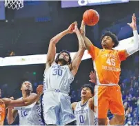  ?? SOUTHEASTE­RN CONFERENCE PHOTO ?? Tennessee’s Keon Johnson and Kentucky’s Olivier Sarr fight for a rebound during the 82-71 win by the Volunteers in Rupp Arena on Feb. 6. Johnson scored a career-high 27 points against the Wildcats, who will visit Tennessee this afternoon.