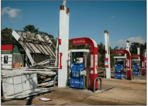  ?? (Bloomberg News/Bryan Tarnowski) ?? An Exxon Mobil Corp. gas station is in ruin after Hurricane Delta struck Oct. 10 near Abbeville, La. Low oil prices has the company delaying major projects and laying off some employees.