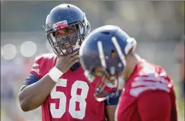  ?? ALLEN EYESTONE / THE PALM BEACH POST ?? Last year’s injury hasn’t slowed tackle Reggie Bain (left), who has started all 12 games this season for the nation’s No. 10 scoring offense.