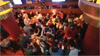  ?? (Sarah Levi) ?? FOOTBALL FANS of all ages and from all background­s gather at Mike’s Place, a bar in central Jerusalem, early Monday morning to watch Super Bowl LII.