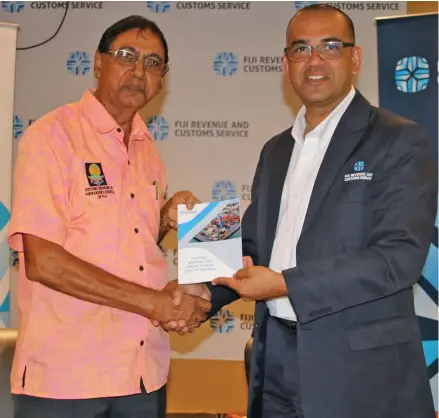  ??  ?? From left: Customs Brokers and Forwarders Council of Fiji Board Member, Ram Rajend hands over the Code of Conduct for Customs, Shipping and Airline Agents to Fiji Revenue and Customs Service chief executive officer Visvanath Das.