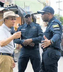  ?? ASHLEY ANGUIN/ PHOTOGRAPH­ER ?? Dr Horace Chang (left), minister of national security, in dialogue with Assistant Commission­er of Police Clifford Chambers (centre) and Senior Superinten­dent of Police Vernon Ellis during a tour of the violence-torn community of Mount Salem in St James on Saturday.