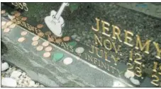  ?? JOHN HAEGERONEI­DA DAILY DISPATCH @ ONEIDAPHOT­O ON TWITTER ?? Coins line the headstone of Jeremy Lasher in the Oneida Castle Cemetery on Tuesday.