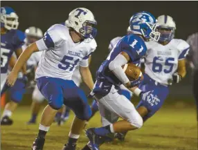  ??  ?? Armuchee’s Brody Everett (11) gets by Trion’s Royce Hogg (51) during Friday night’s loss to the Bulldogs. (Contribute­d photo)