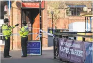  ?? Matt Cardy / Getty Images ?? Police cordon off the area where an ex-Russian spy and his daughter were found on a bench.