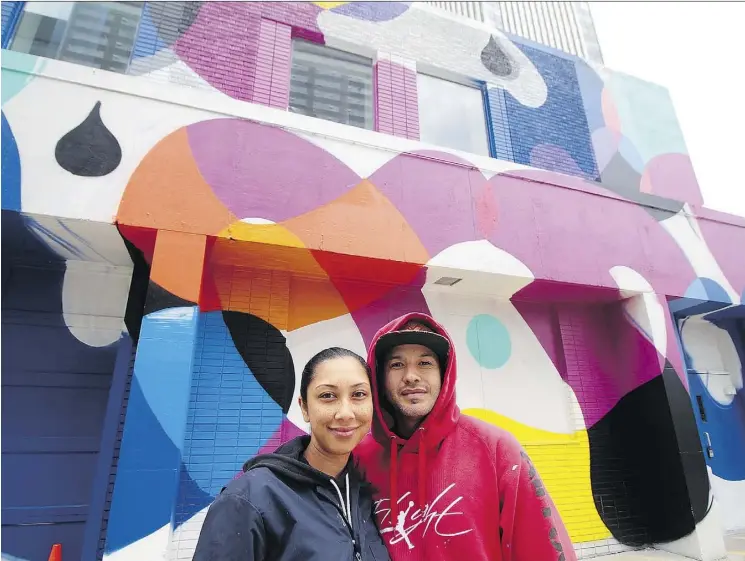  ?? PHOTOS: FISH GRIWKOWSKY ?? Rust Magic organizers Annaliza Toledo and Trevor Peters show off their mural on the Vignettes Building at 10004 103A Ave.