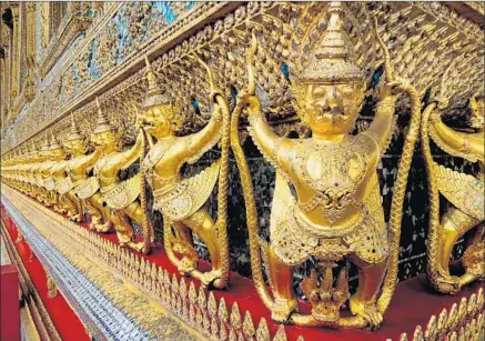  ?? Rosemary McClure ?? GOLDEN GUARDIANS
report for duty at the Temple of the Emerald Buddha in Bangkok, Thailand’s, Grand Palace complex.